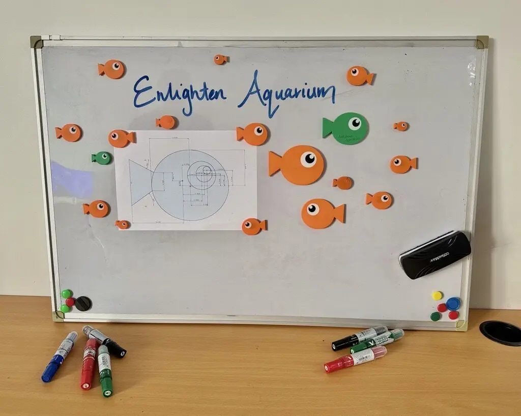 a white board with magnets and fish on it